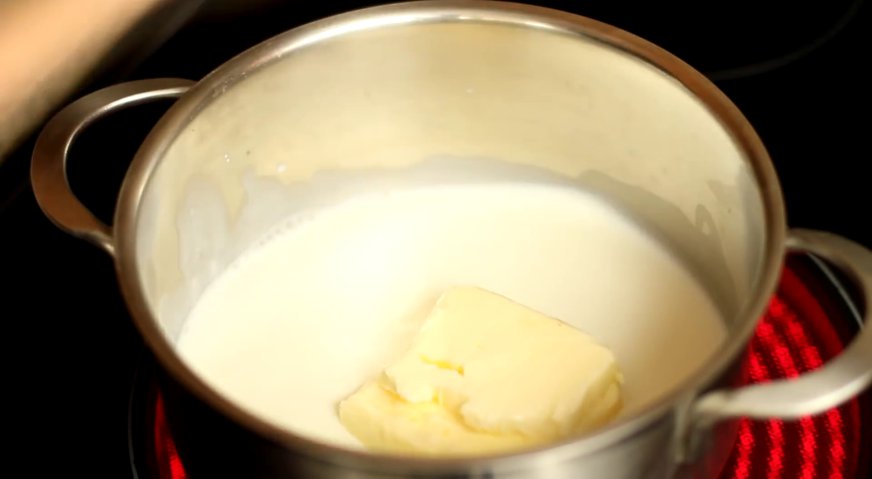 Классические эклеры: Наливаем в кастрюлю молоко, добавляем сливочное масло, и ставим на огонь. Помешиваем, чтобы масло растворилось, но не даём закипеть.